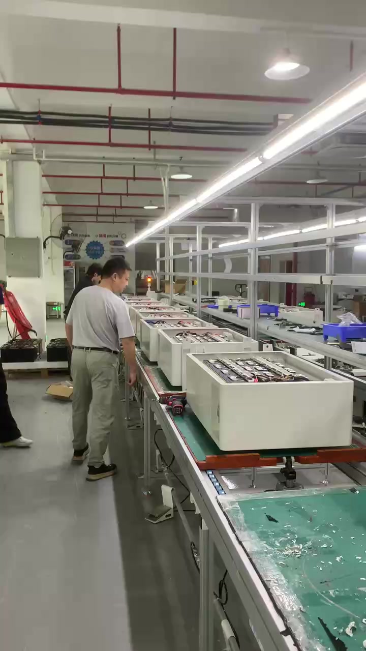 Production line — operator inspecting a storage unit